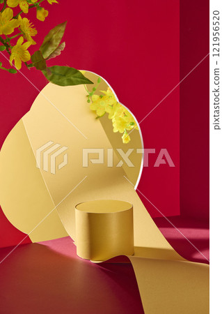 A product display with a Lunar New Year theme, frontal of an empty golden circular platform. In a red wall, a cutout of a flower shows flowing yellow paper, yellow apricot blooms, and a gold backdrop. A product display with a Lunar New Year theme, frontal of an empty golden circular platform. In a red wall, a cutout of a flower shows flowing yellow paper, yellow apricot blooms, and a gold backdrop. 121956520