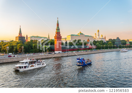 View of Kremlin with Vodovzvodnaya tower, Grand Kremlin Palace from repaired Bolshoy Kamenny Bridge in Moscow city on sunny summer day. Cruise ship sails on the Moscow river 121956583