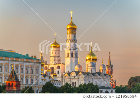 Ivan the Great Bell Tower, with Assumption Belfry on the right in Moscow Kremlin. Blue sky background with sunbeams 121956584