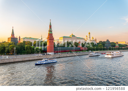 View of Kremlin with Vodovzvodnaya tower, Grand Kremlin Palace from repaired Bolshoy Kamenny Bridge in Moscow city on sunny summer day. Cruise ship sails on the Moscow river 121956588