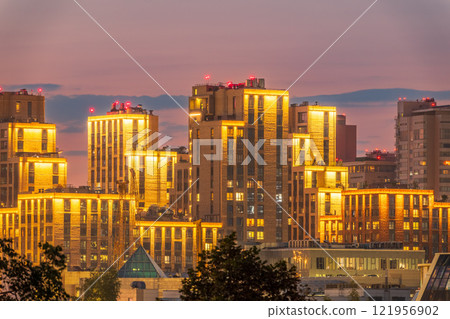 Night colorful windows lights of the high-rise residential building in city sleeping area Night colorful windows lights of the high-rise residential building in city sleeping area 121956902