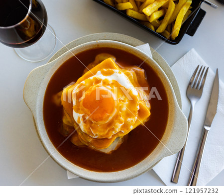 Francesinha, popular Portuguese sandwich with beer sauce 121957232