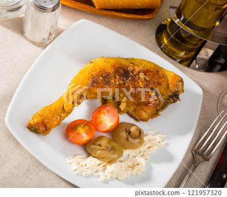 Roasted chicken leg quarter with baked onions and sauce Roasted chicken leg quarter with baked onions and sauce 121957320