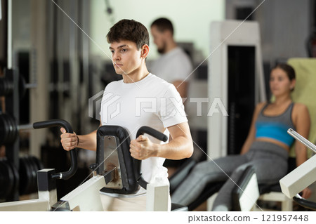 Guy doing strength training on his back Guy doing strength training on his back 121957448