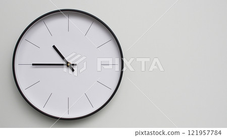 Wall Clock Showing 22.45/10.45 O'Clock on White Wooden Surface - Perfect for Time Management and Scheduling Concepts Wall Clock Showing 22.45/10.45 O'Clock on White Wooden Surface - Perfect for Time Management and Scheduling Concepts 121957784