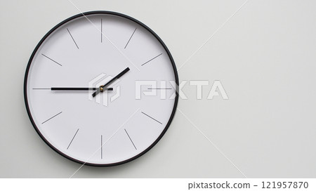 Wall Clock Showing 13.45/01.45 O'Clock on White Wooden Surface - Perfect for Time Management and Scheduling Concepts 121957870