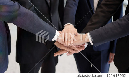 The hands of a business person clasping their hands together The hands of a business person clasping their hands together 121957962