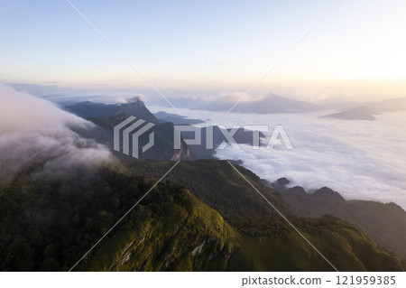 Landscape of Morning Mist with Mountain Layer at north of chiang rai Thailand. mountain ridge and clouds in rural jungle bush forest Landscape of Morning Mist with Mountain Layer at north of chiang rai Thailand. mountain ridge and clouds in rural jungle bush forest 121959385