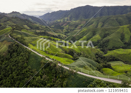 Landscape of Morning Mist with Mountain Layer. mountain ridge and clouds in rural jungle bush forest Landscape of Morning Mist with Mountain Layer. mountain ridge and clouds in rural jungle bush forest 121959431