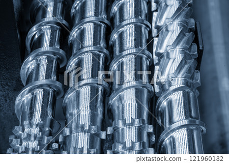 Close up scene body of the barrel screw of injection machine spare parts in the light blue scene. 121960182