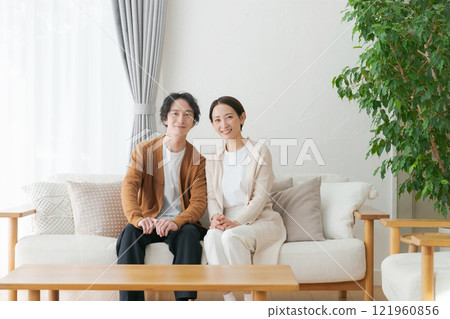 A relaxing couple in the living room 121960856