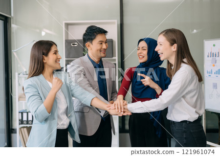 Teamwork business concept of group of three coworkers join hand together during their meeting. 121961074