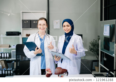 Successful team of medical doctors looking at camera and smiling while standin. Health, professional and people team in hospital Successful team of medical doctors looking at camera and smiling while standin. Health, professional and people team in hospital 121961288
