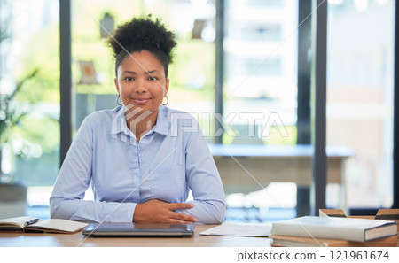 Proud and relaxed business woman or financial advisor consultant with a positive mindset and vision at the office. Portrait of a young accountant smiling ready for work sitting at her desk smiling 121961674
