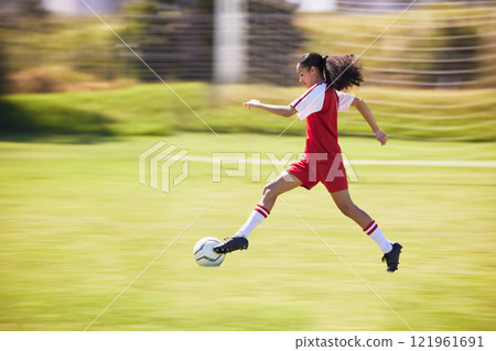 Football, soccer and running girl with a ball doing a sport exercise, workout and training. Moving and young woman athlete in a sports player team uniform runing for fitness cardio on a grass field 121961691