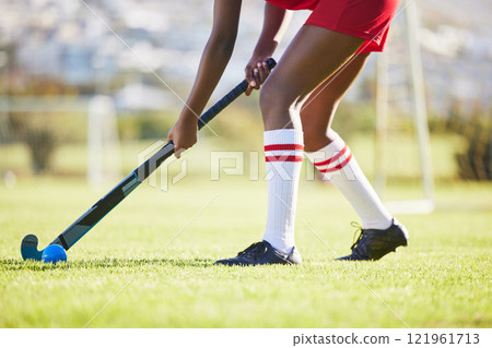 Hockey practice or game workout or sports training with a player exercise fitness for a match or sport field event. Strong athlete being active, healthy and fit running outside with ball with a stick Hockey practice or game workout or sports training with a player exercise fitness for a match or sport field event. Strong athlete being active, healthy and fit running outside with ball with a stick 121961713