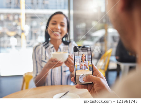 Love, coffee and a cafe, a happy couple meeting for a breakfast date in the city. A man taking a photo of woman on his phone, she has a smile on her face and a cup in her hands, friends and memories. Love, coffee and a cafe, a happy couple meeting for a breakfast date in the city. A man taking a photo of woman on his phone, she has a smile on her face and a cup in her hands, friends and memories. 121961743