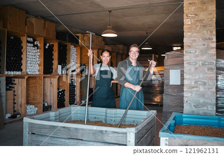 Wine making, production and cellar workers crush, blend and stir open tank for alcohol process. Portrait of happy staff in factory and winery industry for distillery and manufacturing warehouse 121962131