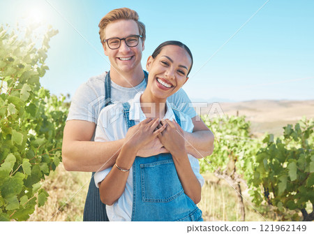 In love, countryside and farmer couple enjoying grape vine plant growth development in summer with flare or sunlight and blue sky. Happy, young rustic people hugging on a sustainable farm or vineyard In love, countryside and farmer couple enjoying grape vine plant growth development in summer with flare or sunlight and blue sky. Happy, young rustic people hugging on a sustainable farm or vineyard 121962149