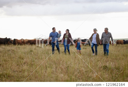 Farming, sustainability and family community on a farm walking together with cows in the background. Happy agriculture countryside group relax holding hands in a green sustainable field in nature Farming, sustainability and family community on a farm walking together with cows in the background. Happy agriculture countryside group relax holding hands in a green sustainable field in nature 121962164