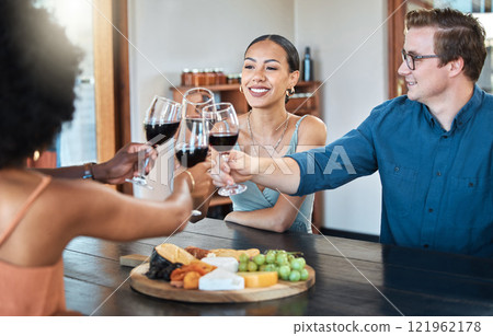 Friends, fun and celebration with diverse group toasting with red wine to good news, bonding at a restaurant. Young friends reunion, happy to be together and enjoy wine tasting with charcuterie board Friends, fun and celebration with diverse group toasting with red wine to good news, bonding at a restaurant. Young friends reunion, happy to be together and enjoy wine tasting with charcuterie board 121962178