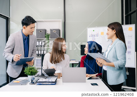 Multiracial group of young creative people in smart casual wear discussing business brainstorming meeting ideas design project. Multiracial group of young creative people in smart casual wear discussing business brainstorming meeting ideas design project. 121962408