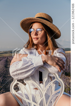Woman Lavender Field Summer Fashion: Relaxed pose, sunlit, outdoor photoshoot, Provence-style. Woman Lavender Field Summer Fashion: Relaxed pose, sunlit, outdoor photoshoot, Provence-style. 121962486