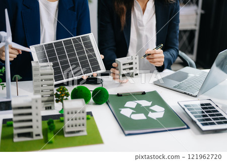 business team people planning and discussing on recycle reduce reuse policy symbol in office room. Green business company and Solar Energy Environment city Concept. business team people planning and discussing on recycle reduce reuse policy symbol in office room. Green business company and Solar Energy Environment city Concept. 121962720