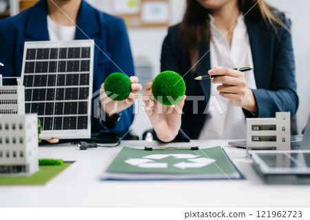 business team people planning and discussing on recycle reduce reuse policy symbol in office room. Green business company and Solar Energy Environment city Concept. business team people planning and discussing on recycle reduce reuse policy symbol in office room. Green business company and Solar Energy Environment city Concept. 121962723