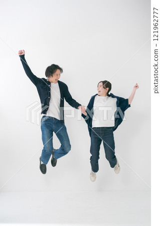 Couple holding hands and jumping Couple holding hands and jumping 121962777