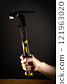 Hand holding hammer, which is perfect for an array of DIY tasks and home improvement projects 121963020