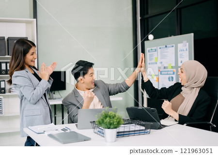 Young attractive Asian male office worker business  Asian male office worker business suits smiling at camera in office . teamwork startup concept 121963051