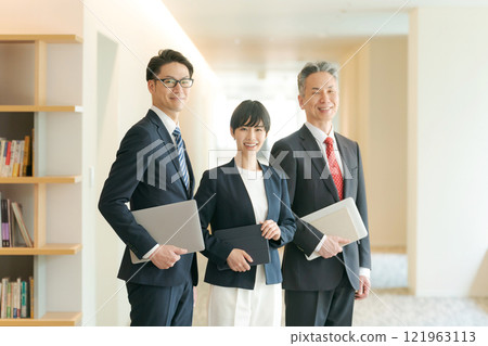 Business people lining up in an office corridor Business people lining up in an office corridor 121963113