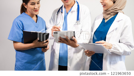 Successful team of medical doctors looking at camera and smiling while standin. Health, professional and people team 121963650