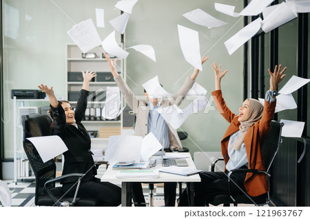 Diverse teams celebrating success in a lively office setting, capturing moments of joy, teamwork, 121963767