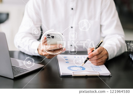 Businessman working with smart phone and laptop and digital tablet computer in office with digital marketing media in virtual icon Businessman working with smart phone and laptop and digital tablet computer in office with digital marketing media in virtual icon 121964580