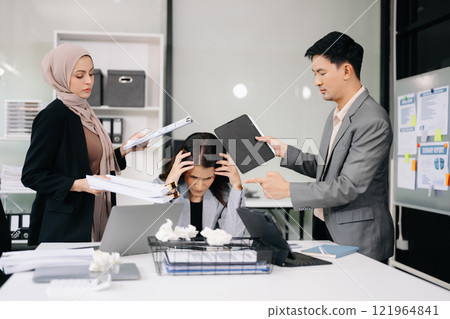 Stressed Asian Businesswoman Surrounded by Overwhelming Paperwork Concept of Workplace Anxiety and Overwork Stressed Asian Businesswoman Surrounded by Overwhelming Paperwork Concept of Workplace Anxiety and Overwork 121964841