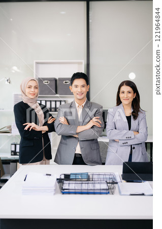 Business partners sitting at officeand smiling at camera. Executives  successful business team 121964844