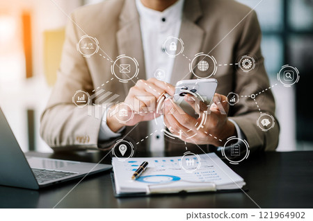 Businessman working with smart phone and laptop and digital tablet computer in office with digital marketing media in virtual icon Businessman working with smart phone and laptop and digital tablet computer in office with digital marketing media in virtual icon 121964902
