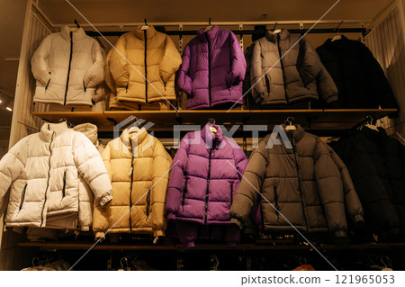 winter jackets on the store shelf. warm clothes on sale in the showroom winter jackets on the store shelf. warm clothes on sale in the showroom 121965053