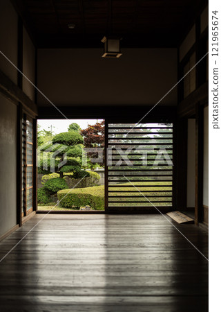 View of a Japanese garden from inside a Japanese house 121965674