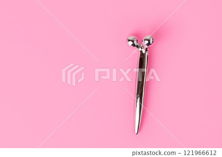 Face massager on pastel pink background Face massager on pastel pink background 121966612