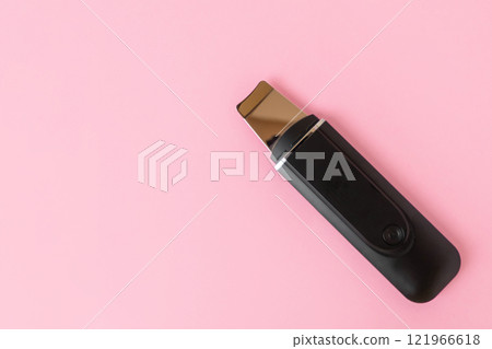 Ultrasonic skin scrubber on pink background Ultrasonic skin scrubber on pink background 121966618