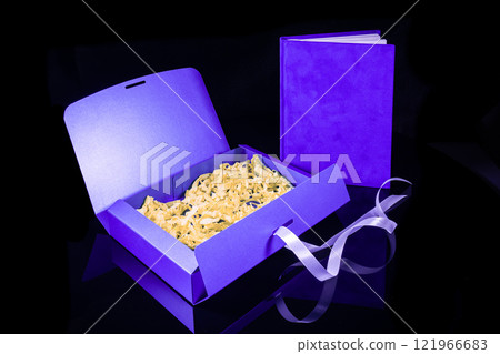 Best gift for men. Man gift concept. Blue notebook with blue gift box on black background. Copy space text. Valentine's day, wedding, birthday and special occasion gift concept. Copy space for text. 121966683