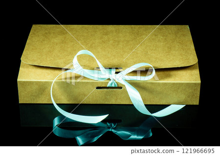 Man gift concept. gift box wrapped in dark black paper with luxury bow on dark background. Horizontal with copy space. 121966695