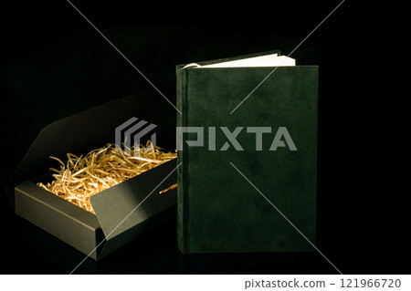 Best gift for men. Man gift concept. Black notebook with black gift box on black background. Copy space text. Valentine's day, wedding, birthday and special occasion gift concept. Copy space for text. 121966720