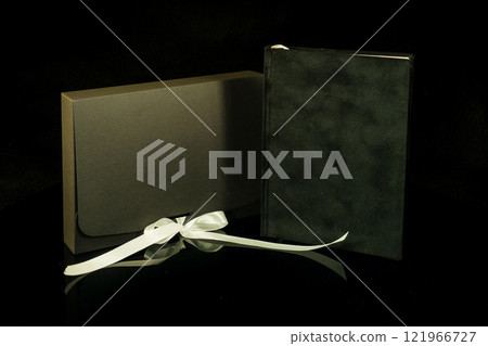 Best gift for men. Man gift concept. Black notebook with black gift box on black background. Copy space text. Valentine's day, wedding, birthday and special occasion gift concept. Copy space for text. 121966727