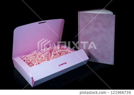 Best gift for men. Man gift concept. Pink notebook with Pink gift box on black background. Copy space text. Valentine's day, wedding, birthday and special occasion gift concept. Copy space for text. 121966739