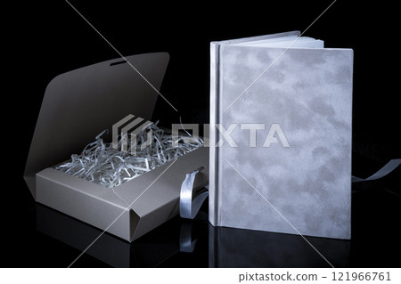 Best gift for men. Man gift concept. Notebook with craft gift box on black background. Copy space text. Valentine's day, wedding, birthday and special occasion gift concept. Copy space for text. 121966761