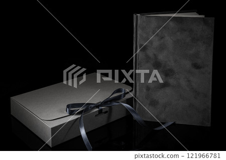Best gift for men. Man gift concept. Grey notebook with Grey gift box on black background. Copy space. Valentine's day, wedding, birthday and special occasion gift concept. Copy space for text. 121966781